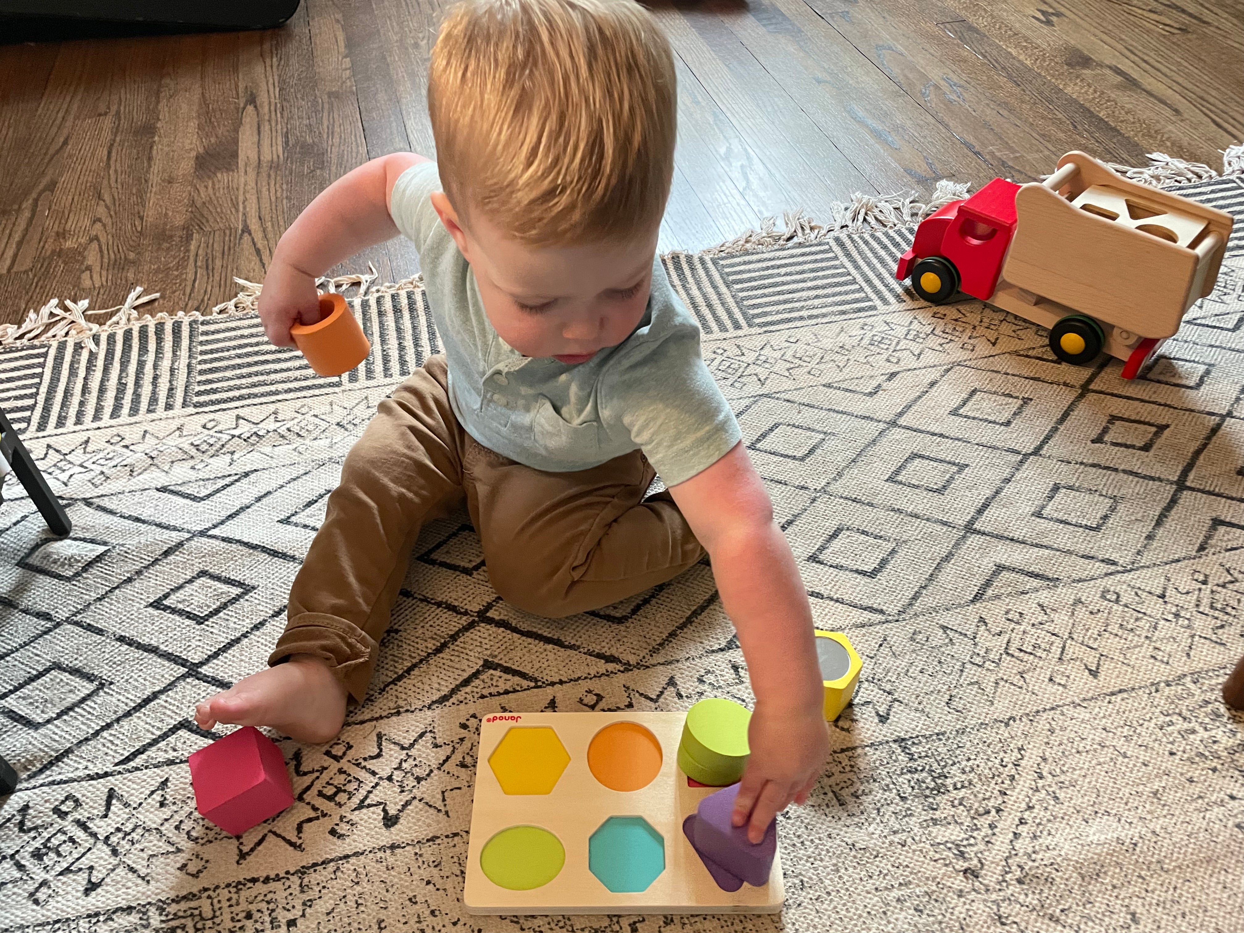 Little boy playing with wooden toys