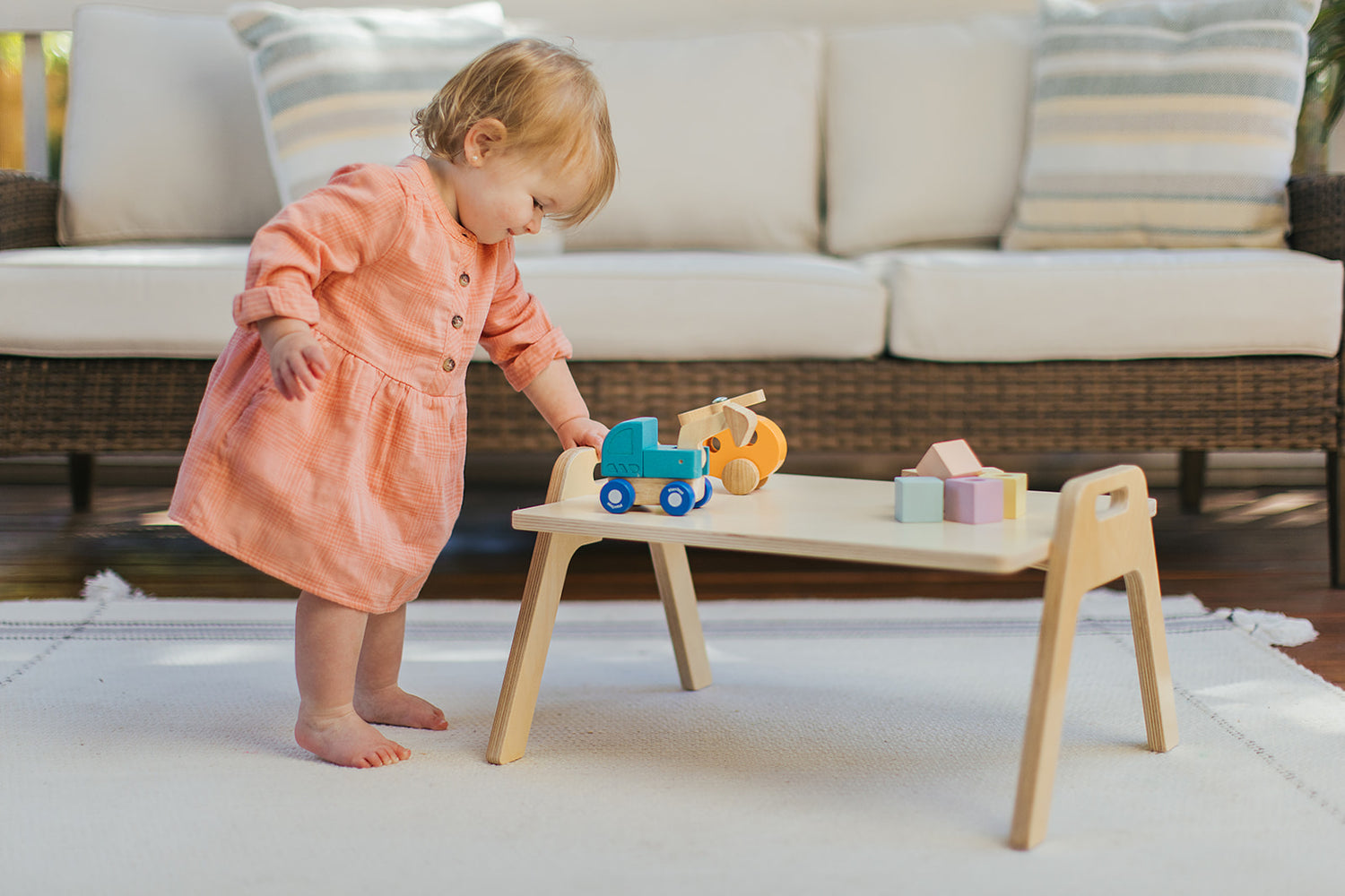 Little girl playing with wooden toys